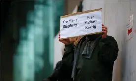  ??  ?? A man holds a sign calling for China to release the dissident Wang Bingzhang and exCanadian diplomat Michael Kovrig at a bail hearing for the Huawei CFO, Meng Wanzhou, in Vancouver. Photograph: Lindsey Wasson/Reuters