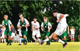  ?? MIKE CAUDILL/ FREELANCE ?? Menchville’s Matt Fitzer scores a goal on a penalty kick to tie the game at 1 on Tuesday at Kecoughtan in Hampton.