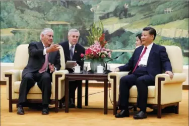  ?? ANDY WONG — THE ASSOCIATED PRESS ?? U.S. Secretary of State Rex Tillerson, left, chats with China’s President Xi Jinping during a meeting at the Great Hall of the People in Beijing, Saturday.