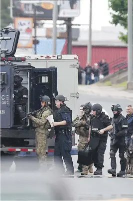  ?? ANDREW VAUGHAN / THE CANADIAN PRESS ?? Officers in Moncton, N.B., search for a suspect who killed three RCMP officers in June 2014. One of the Mounties who was wounded says he needed more powerful weapons.