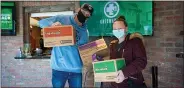  ?? COURTESY PHOTO ?? Jerry Millen and Jennifer Slayden with some of the 300 boxes of Girl Scout cookies Millen purchased from the troop.