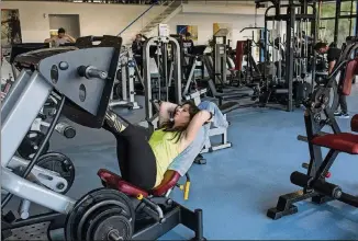  ?? PHOTOS BY DANIEL RODRIGUES/THE NEW YORK TIMES ?? Oriana Sousa, who had a rare, aggressive form of ovarian cancer, works out in Marinha Grande, Portugal, Feb. 10. Traditiona­l treatments failed, but with immunother­apy her tumors shrank so much that there is no evidence of disease.