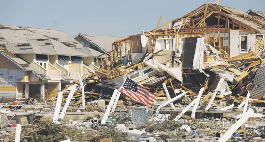  ?? Picture: Reuters ?? STILL THERE. An American flag lies amongst rubble left in the aftermath of Hurricane Michael in Mexico Beach, Florida.