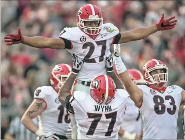  ?? Kenneth Ward / RN-T ?? Georgia running back Nick Chubb (27) is hoisted in the air by Isaiah Wynn after scoring a touchdown against Oklahoma in the Rose Bowl. The Cedartown alum is part of college football’s top tailback duo along with Sony Michel.