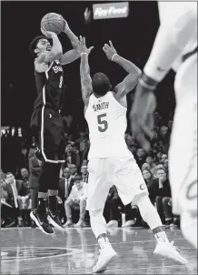  ?? FRANK FRANKLIN II/AP PHOTO ?? Brooklyn’s Spencer Dinwiddie shoots a 3-pointer over Cleveland’s JR Smith during the second half of Wednesday’s game at Barclays Center. The Nets won, 112-107.