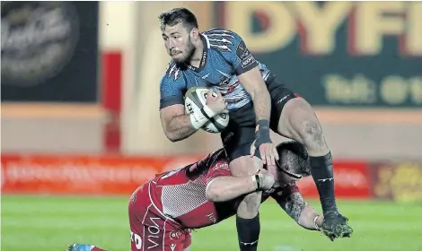  ?? Picture: CHRIS FAIRWEATHE­R/GALLO IMAGES ?? EAGER FOR ACTION: Erich Cronje of the Southern Kings is tackled by Phil Price of Scarlets during their Guinness PRO14 matchat Parc y Scarlets in Llanelli in February