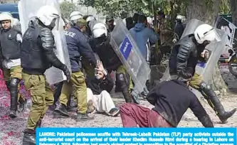  ??  ?? LAHORE: Pakistani policemen scuffle with Tehreek-Labaik Pakistan (TLP) party activists outside the anti-terrorist court on the arrival of their leader Khadim Hussain Rizvi during a hearing in Lahore on February 4, 2019, following last year’s violent protest in opposition to the acquittal of a Christian woman from blasphemy charges. —AFP
