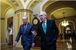  ?? AL DRAGO / THE NEW YORK TIMES ?? Senate Minority Leader Chuck Schumer (left), D-N.Y., and Majority Leader Mitch McConnell, R-Ky., leave McConnell’s office Wednesday after budget discussion­s on Capitol Hill. Congress finally reached a deal early Friday.