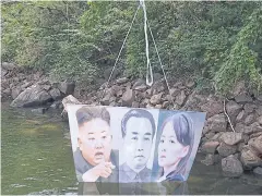  ?? AFP ?? A balloon carrying a banner with portraits of North Korean leader Kim Jong-un, the late leader Kim Il-sung, and Kim Yo-jong, sister of Kim Jong-un.