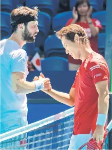  ?? — AFP photo ?? Yoshihito Nishioka (right) is congratula­ted by Nikoloz Basilashvi­li of Georgia after their seventh session men’s singles match on day four of the ATP Cup tennis tournament in Perth.
