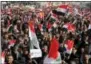  ?? THE ASSOCIATED PRESS ?? Followers of Iraq’s influentia­l Shiite cleric Muqtada alSadr chant slogans as they wave national flags during a demonstrat­ion against corruption in Baghdad, Iraq, Saturday.