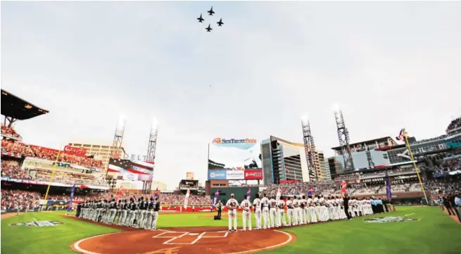  ?? AP ?? ATLANTA: United States Navy fighter jets fly over SunTrust Park during the national anthem before a baseball game between the Atlanta Braves and the San Diego Padres.—