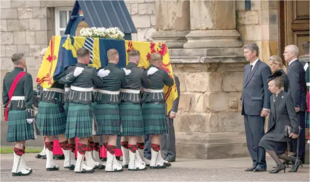  ?? Associated Press ?? The coffin of Queen Elizabeth II completes its journey from Balmoral to the Palace of Holyroodho­use in Edinburgh on Sunday.