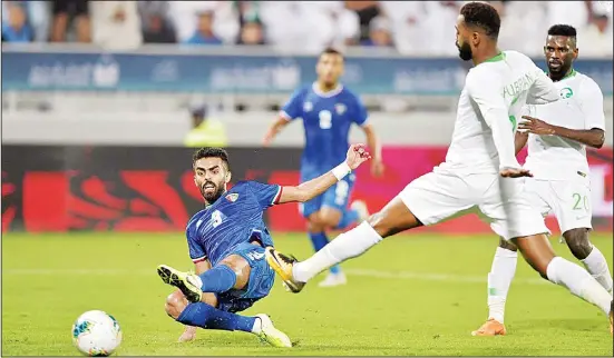  ??  ?? Kuwaiti player wins the ball during Group B soccer match between Kuwait and Saudi Arabia