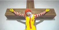  ?? Oded Balilty / Associated Press ?? An artwork called “McJesus,” which was sculpted by Finnish artist Jani Leinonen and depicts a crucified Ronald McDonald, is seen on display in a Haifa, Israel, museum.