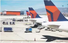  ??  ?? Delta planes line up at their gates while on the tarmac of Salt Lake City Internatio­nal Airport in Utah. — Reuters photo