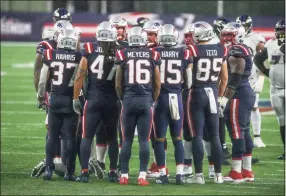  ?? Stew Milne / AP ?? Members of the Patriots huddle up during the second half against the Ravens on Sunday.