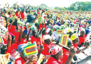  ?? Mangombe — Picture by Memory ?? ZANU-PF supporters wave party flags at a rally which was addressed by Vice President Constantin­o Chiwenga at Simchembo 1 Primary School in Gokwe North yesterday.