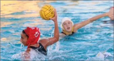  ?? MIKE BUSH/NEWS-SENTINEL ?? Lodi's Jackie Westerterp (13) gets ready to fire the ball into the net in Tuesday's TCAL and cross-town girls water polo match at the Tigers' swimming pool. Westerterp had two goals in the second period that led to the Flames beating the Tigers 7-6.