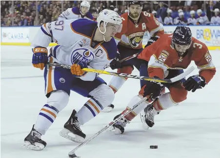  ?? AP PHOTO ?? SLICK MOVE: Panthers defenseman Keith Yandle (right) fends off the Oilers’ Connor McDavid as they battle for the puck during last night’s game in Sunrise, Fla.