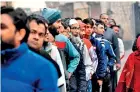  ??  ?? People queue at a polling station to cast their votes during the Legislativ­e Assembly elections in New Delhi on February 8, 2020. (Photo by Sajjad HUSSAIN / AFP)