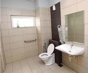  ?? FILE PIC ?? The disabled-friendly toilet is more spacious, has a handlebar and lower-placed toilet and sink.