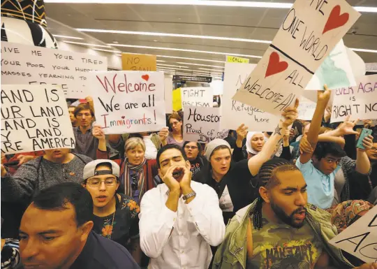  ?? Brett Coomer / Houston Chronicle 2017 ?? Demonstrat­ors protested anti-immigrant policies and a Muslim travel ban instituted via executive order by the Trump administra­tion last year at George Bush Interconti­nental Airport in Houston.