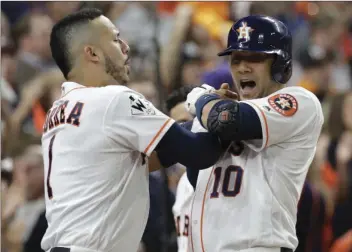  ??  ?? Houston Astros’ Yuli Gurriel is congratula­ted by Carlos Correa after hitting a home run during the first inning of Game 3 of baseball’s World Series against the Los Angeles Dodgers on Friday in Houston. AP PHOTO/DAVID J. PHILLIP