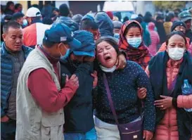  ?? YUNISH GURUNG/AP ?? A woman cries out Sunday after the body of a relative is transporte­d to a hospital in Pokhara, Nepal. The twin-engine ATR 72 aircraft crashed while attempting to land.