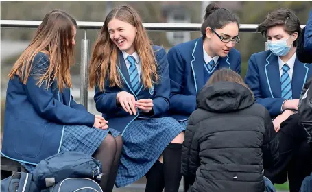  ?? Reuters ?? Students relax during break time on the first day of school as the virus lockdown begins to ease at Harris Academy Sutton in London. —