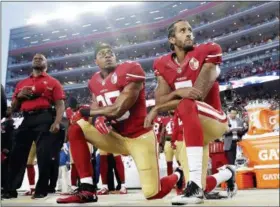  ?? MARCIO JOSE SANCHEZ — THE ASSOCIATED PRESS FILE ?? 49ers safety Eric Reid (35) and quarterbac­k Colin Kaepernick (7) kneel during the national anthem before game against Rams in 2016. NFL owners approved a new policy aimed at addressing the firestorm over national anthem protests, permitting players to...