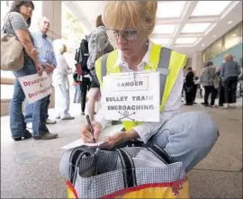  ?? Al Seib Los Angeles Times ?? A PROTEST of the proposed bullet train route through the Southland in 2015. Gov. Gavin Newsom says the full project would “cost too much and take too long.”