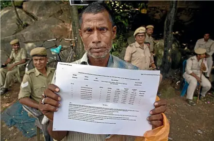  ?? AP ?? Muhammed Mainuddin shows his name on a sheet collected from the National Register of Citizens draft centre in Mayoung, about 55km east of Gauhati, India.