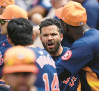  ?? RICH STORRY/GETTY ?? The Astros’ Jose Altuve talks to teammates prior to a March 12 spring training game against the Marlins at Roger Dean Stadium in Jupiter, Florida.