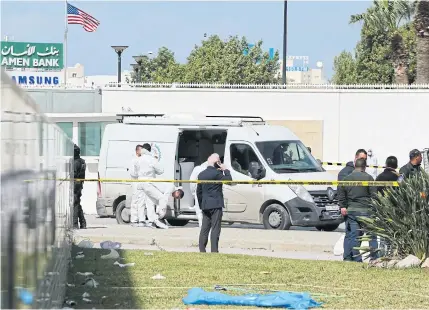  ??  ?? STATE OF EMERGENCY: Police and forensic experts inspect the scene of an explosion near the US embassy in the Tunisian capital Tunis on Friday.