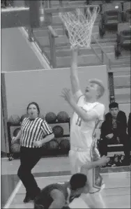  ?? MARK HUMPHREY ENTERPRISE-LEADER ?? Farmington’s Mason Downs goes to the hoop against Springdale High. The Cardinals suffered a 17-minute scoring drought which contribute­d to a 69-39 loss to the 7A Bulldogs on Dec. 5.