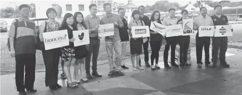  ??  ?? Boon (centre), Leong (seventh right) and Awang (sixth right) with sponsors and co-sponsors in front of the Square Tower after the press conference yesterday.