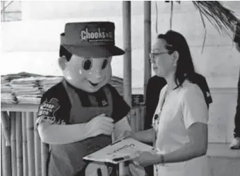  ??  ?? Chooks-to-Go mascot helps distribute flags to Davao City’s public elementary and junior high schools.