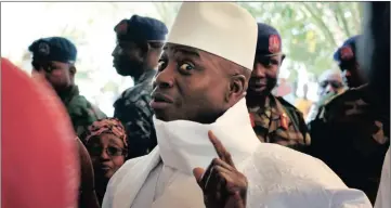  ??  ?? NOT GOING AMYWHERE : Gambia’s President Yahya Jammeh shows his inked finger before voting in Banjul. Jammeh declared a state of emergency on Tuesday after losing elections last month.