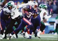  ?? Adam Glanzman / Getty Images ?? Damien Harris (37) of the New England Patriots carries the ball against the New York Jets during the third quarter at Gillette Stadium on Sunday in Foxborough, Mass.