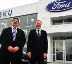  ??  ?? Co-owners Bob Wispinski, left, and Neil Reid in front of the newly constructe­d Nisku Ford.