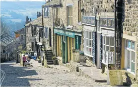  ??  ?? STEP TO IT: Haworth’s main street is packed with quaint shops and tearooms