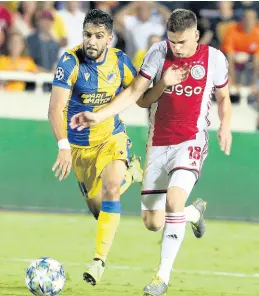  ?? AP ?? Ajax’s Razvan Marin (right) challenges for the ball with APOEL’s Musa Suleiman during their teams’ Champions League qualifying play-off firstleg match at GSP stadium in Nicosia, Cyprus, yesterday.
