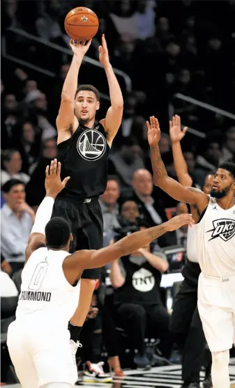  ?? Photos by Scott Strazzante / The Chronicle ?? Team Stephen’s Klay Thompson rises for a three-point try despite the defense of Team LeBron’s Andre Drummond and Paul George in the second quarter.