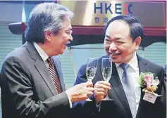  ??  ?? Postal Savings Bank of China Chairman Li Guohua (right) toasts with Hong Kong Financial Secretary John Tsang during the listing of the bank, the world’s biggest initial public offering in two years, at the Hong Kong Stock Exchange in Hong Kong. —...