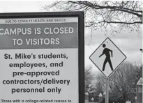  ??  ?? In this Nov. 12 photo, a sign at the entrance to St. Michael's College in Colchester, Vt., says that the campus is closed to visitors due to a COVID-19 outbreak. [LISA RATHKE/ASSOCIATED PRESS FILE PHOTO]