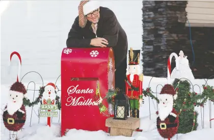  ?? DAVID BLOOM ?? William Johansen, who lost his job at a restaurant, set up a mailbox in his yard where area kids can drop off their letters to Santa Claus. Johansen has personally responded to more than 100 such letters — just one of the many creative ways people are finding to help each other.