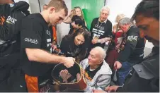  ?? FAMILY PRIDE: New world champion Jeff Horn shows his WBO belt to his grandfathe­r Ray. Picture: PETER WALLIS ??