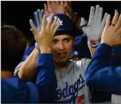  ?? AP NICK WASS ?? Los Angeles Dodgers’ Corey Seager is congratula­ted in the dugout for his three-run home run during the first inning of the team’s baseball game against the Baltimore Orioles, Tuesday, Sept. 10, in Baltimore.