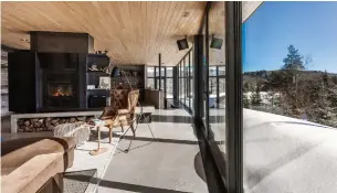  ?? GORINI GUILLAUME PHOTOS SOTHEBY’S INT’L REALTY QUÉBEC ?? A south- facing wall of windows provides the main- floor living room with big views of the natural environmen­t outside, including protected land and pristine lakes.